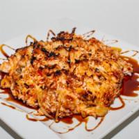 Baked Volcano Roll · Inside: avocado, cucumber and crabmeat. Outside: scallop, masago, crabmeat and onion mixed w...