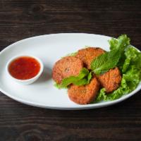 A14. Fish Cake · 4 pieces. Ground fish, string bean, lime leaves, and red curry paste with sweet chili sauce.