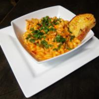 Santa Fe Chicken Pasta · Cavatappi pasta tossed in our spicy santa-fe cream sauce, grilled chicken, bell peppers, oni...