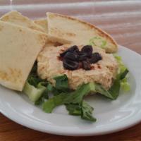 24. Hummus Salad · Hummus, olives, paprika, romaine lettuce, and olive oil.