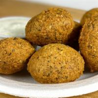 Falafel · Golden brown nuggets of ground chickpeas, parsley, and spices, deep-fried with Tzatziki sauc...