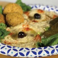 Sampler Platter · Hummus, Baba Ganoush, Dolmas (3 Pieces), Falafel (3 Pieces) with Tzatziki sauce, and pita br...