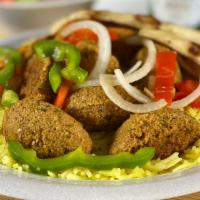 Falafel Plate · Golden brown nuggets of ground chickpeas served with rice, pita bread, salad, and our famous...
