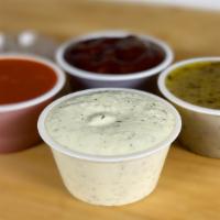 Side Sauces · Variety of different sauces and dressings, including our Tzatziki sauce and house dressing.
