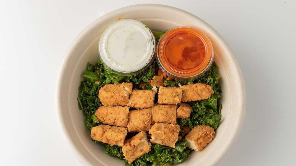 Buffalo CHIK-N® Wrap · Our Buffalo CHIK-N® Wrap served as a bowl. Includes house made CHIK-N® tenders tossed in buffalo sauce, covered in poblano ranch, topped with kale salad and served in a bowl.