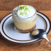 Key Lime Pie · Graham cracker crumb crust with a creamy lime filling, topped with whipped cream.