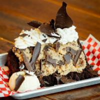Giant German Chocolate Cake · A huge wedge of rich, layered chocolate cake, topped with our delicious, coconut-filled, hou...