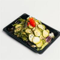 Spicy Cucumber Salad · Cucumber marinated in sweet vinegar, over mixed green, topped with roasted sesame seeds, chi...