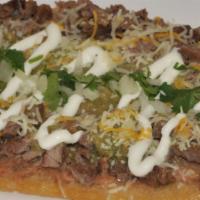 Huarache · Oval shape fired masa, topped with you choice of meat, beans, sour cream, cotija cheese and ...