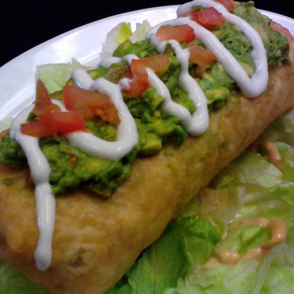 Grande Chimichanga · Deep-fried burrito with your choice of meat, beans and cheese, topped  with guacamole, sour cream, tomatoes and cilantro