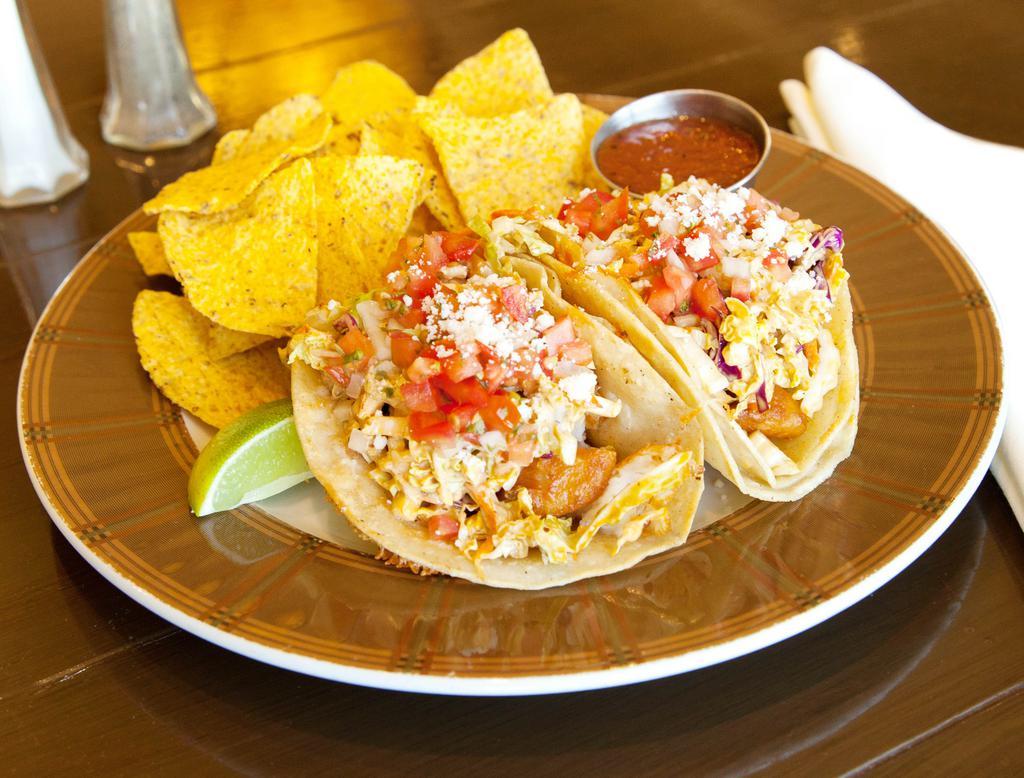 Fish Tacos · Beer battered cod in a cheesy corn tortilla topped with baja slaw, pico de gallo and cotija cheese served with tortilla chips and house made salsa.