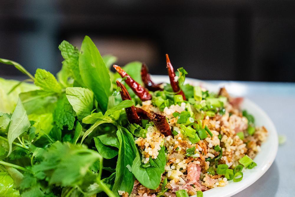 17. Nam Khao Tod · Spicy pork crispy rice with lettuce, cilantro and peanut.