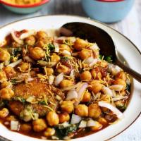 Aloo Tikki Chole · Potato croquette topped with chickpea curry, yogurt and chutney.