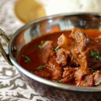 Goat Curry · Braised goat chunks with a gravy of browned onions, garlic, ginger and spices.