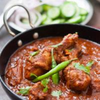 Chicken Vindaloo · A traditional Goan potato dish with chicken, fiery red color, and a slight tang from the vin...