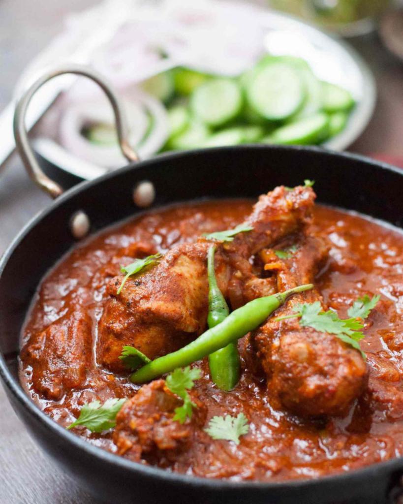 Chicken Vindaloo · A traditional Goan potato dish with chicken, fiery red color, and a slight tang from the vinegar.