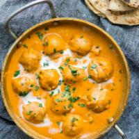 Malai Kofta Curry · Cheese and vegetables dumplings cooked in onion, tomato, cream and almond sauce.