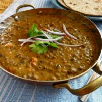 Dal Makhani Curry · Black lentils cooked with herbs and spices and tempered with butter.