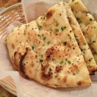Garlic Naan · Traditional naan bread and subtly flavoured with select garlic.
