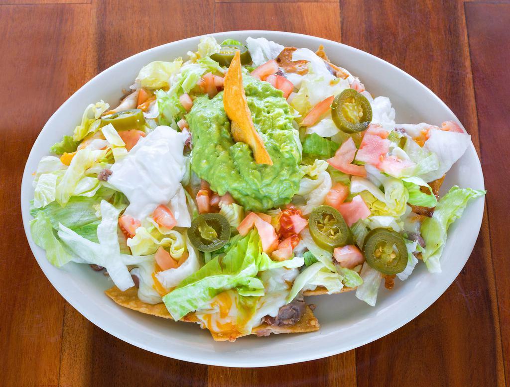 Supreme Nachos · Beans, cheese, lettuce, tomatoes, guacamole, jalapeno and sour cream.