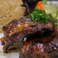 Grilled Pork Spare Ribs · Marinated and char-coaled grilled. Served with jasmine rice and mixed salad.