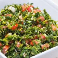 Tabbouleh Salad · Crushed wheat mixed with parsley, tomatoes and onions, dressed with lemon juice and olive oil.
