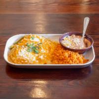 Huevos Rancheros · 3 eggs over crispy corn tortillas topped with salsa ranchera, Queso Cotija and cilantro. Ser...