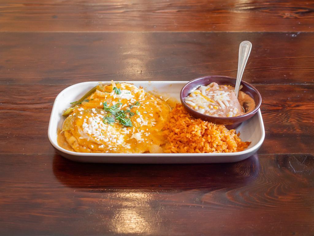 Huevos Rancheros · 3 eggs over crispy corn tortillas topped with salsa ranchera, Queso Cotija and cilantro. Served with beans and rice. (no tortillas on side.)