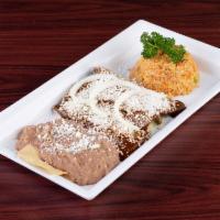 Enchiladas de Mole · Chicken covered in mole sauce, served with queso fresco, rice and beans.