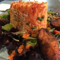 Arroz con Pollo · Seasoned rice with shredded chicken breast, peas and carrots. Gluten Free.