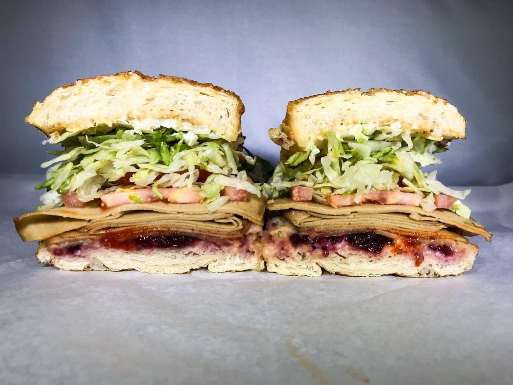 219. Pilgrim Sandwich · Vegan turkey, cranberry sauce, Sriracha and cheddar. Served with dirty sauce, lettuce and tomato.