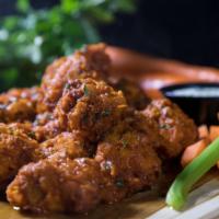 Bone-In or Boneless Wings · Served with your choice of sauce, carrot & celery sticks and your choice of ranch or blue ch...
