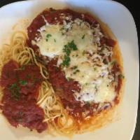 Chicken Parmigiana · Fried breaded chicken breast topped with tomato sauce and mozzarella cheese. Served with a s...