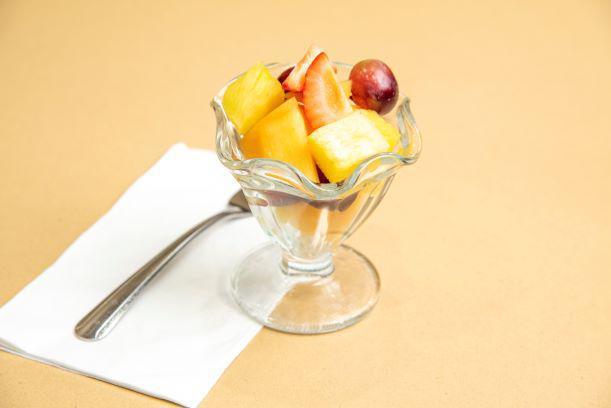 Fruit Salad · Freshly cut cantaloupe and pineapple mixed with red seedless grapes and toped with strawberry pieces. 