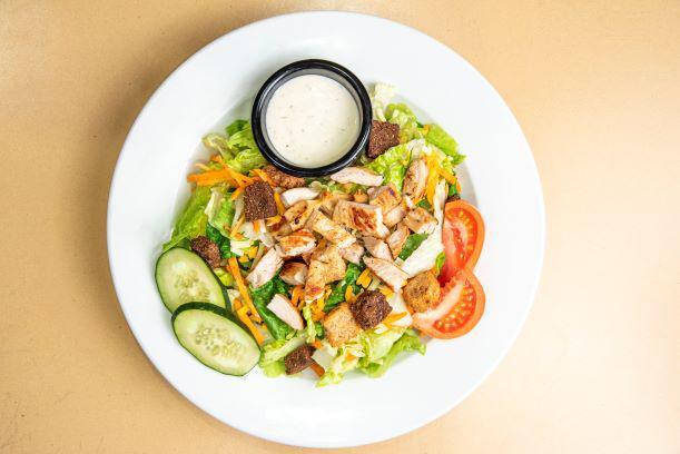 Nature's Garden Grilled Chicken Salad · A fresh mix of lettuce, tomato, two-cheese blend, cucumbers, carrots, and crunchy croutons topped with freshly grilled chicken. Served with your choice of dressing.