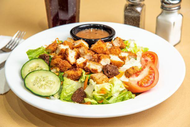 Nature's Garden Crispy Chicken Salad · A fresh mix of lettuce, tomato, two-cheese blend, cucumbers, carrots, and crunchy croutons topped with fried crispy chicken pieces. Served with your choice of dressing.