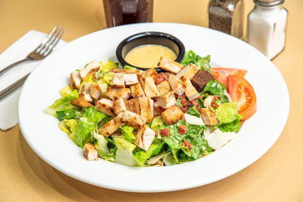 Caesar's Empire Salad with Grilled Chicken · Crisp romaine, tossed in our Caesar dressing with croutons, tomato, shredded Parmesan cheese and bacon bits. 