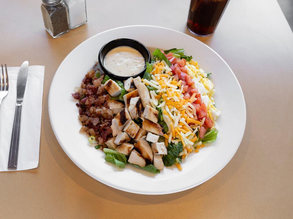 Cobb Salad · A beautiful combination of juicy grilled chicken, crisp bacon, chopped boiled egg, diced tomato, and shredded two-cheese blend on a bed of romaine lettuce. Served with your choice of dressing.