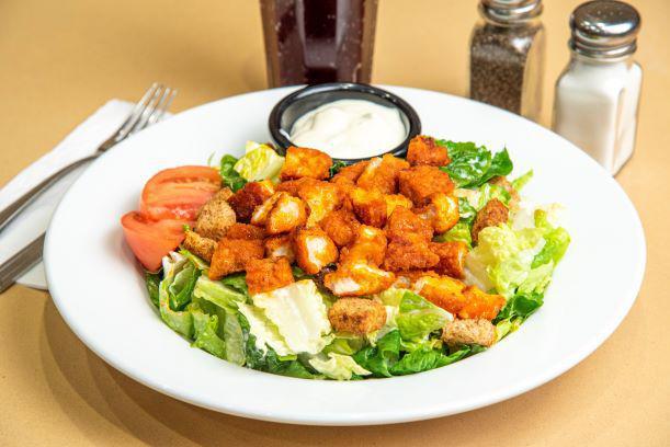Buffalo Bleu Salad · Juicy Buffalo chicken tenders, crispy romaine lettuce, tomato and  croutons topped with bleu cheese dressing.