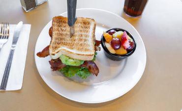 Avocado BLT · Not your average BLT. Between two golden thick slices of Texas toast you will find fresh creamy avocado slices, smoked sugar bacon, crisp lettuce, tasty tomatoes, and mayonnaise. Served with a side choice. 