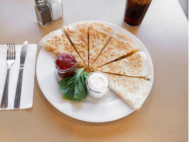 Cheese Quesadilla · A warm white or wheat tortilla with melted cheese, crisp bacon, scallions and tomato. Served with salsa and sour cream.