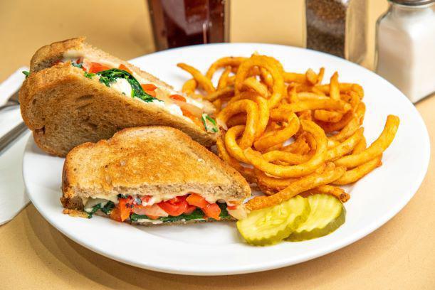 Spinach Pie Grilled Cheese · Out take on the Rhode island staple.. Sautéed spinach, grilled onion, roasted red peppers, feta and American cheeses grilled on rye bread.