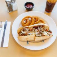 Loaded Philly Cheese Steak Sandwich · Served with peppers and mushrooms. 