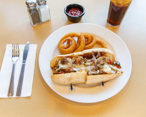 Loaded Philly Cheese Steak Sandwich · Served with peppers and mushrooms. 