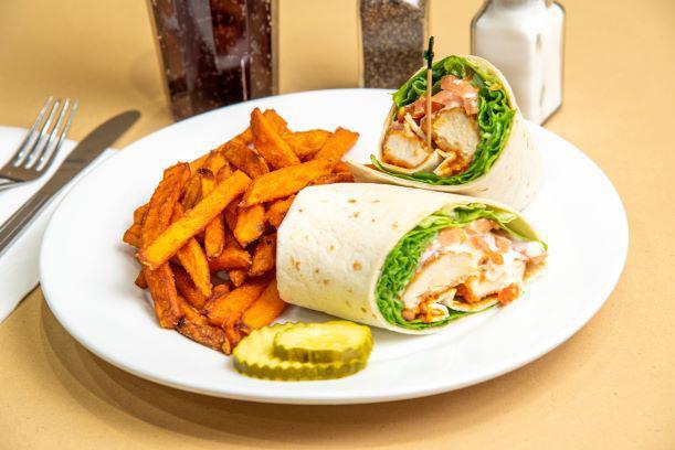 Buffalo Chicken Wrap · Breaded and fried Buffalo style chicken tenders served with crisp lettuce, tomato, and bleu cheese dressing.