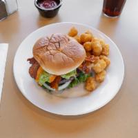 Avocado Bacon Burger · Avocado tops this big beef burger along with bacon, lettuce, tomato, onions, and secret sauc...