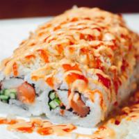Spicy Crazy Roll · Salmon, crab stick, avocado, cucumber, flying fish roe, topped with crunch, spicy sauce.