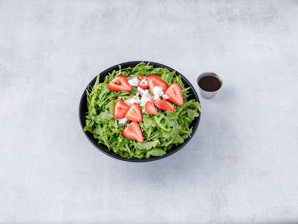 Strawberry Arugula Salad · Baby arugula, fresh strawberries, crumbled goat cheese, topped with honey balsamic dressing. Gluten free.