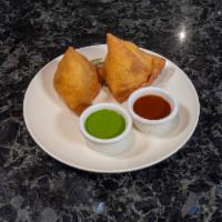 Vegetable Samosa · Deep fried triangles stuffed with spicy potatoes and peas masala served with mint and tamari...