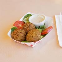 Falafel Plate · A chickpea mixture of onions, parsley, garlic and spices. Deep-fried with salad, hummus, tah...